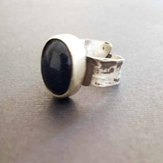 Closed hammered oval cabochon ring with goldstone