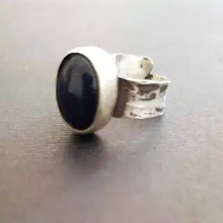 Closed hammered oval cabochon ring with goldstone