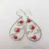 Teardrop silver earring with tiny red amber