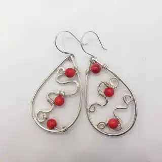 Teardrop silver earring with tiny red amber