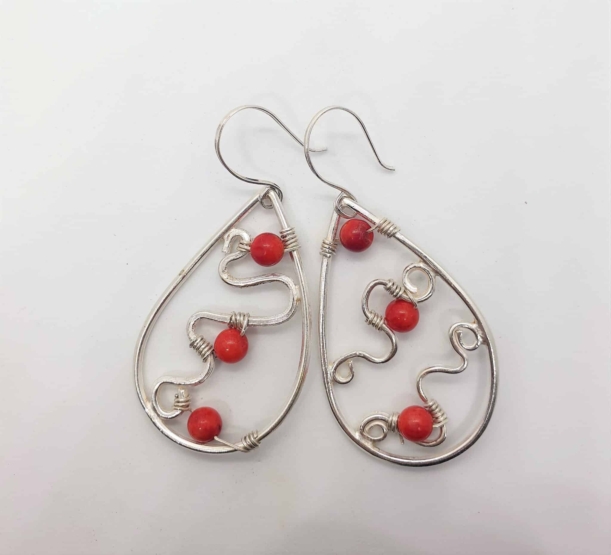 Teardrop silver earring with tiny red amber 1 Teardrop silver earring with tiny red amber