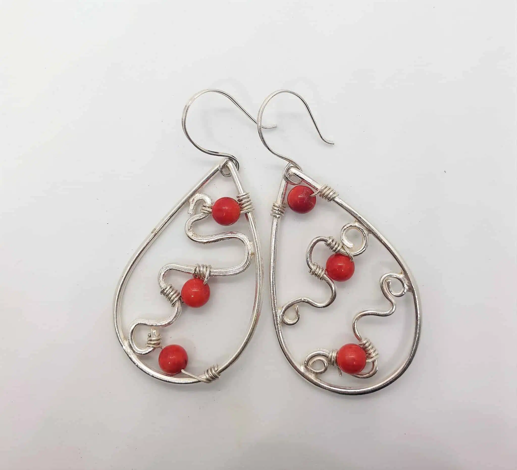 Teardrop silver earring with tiny red amber 1 Teardrop silver earring with tiny red amber