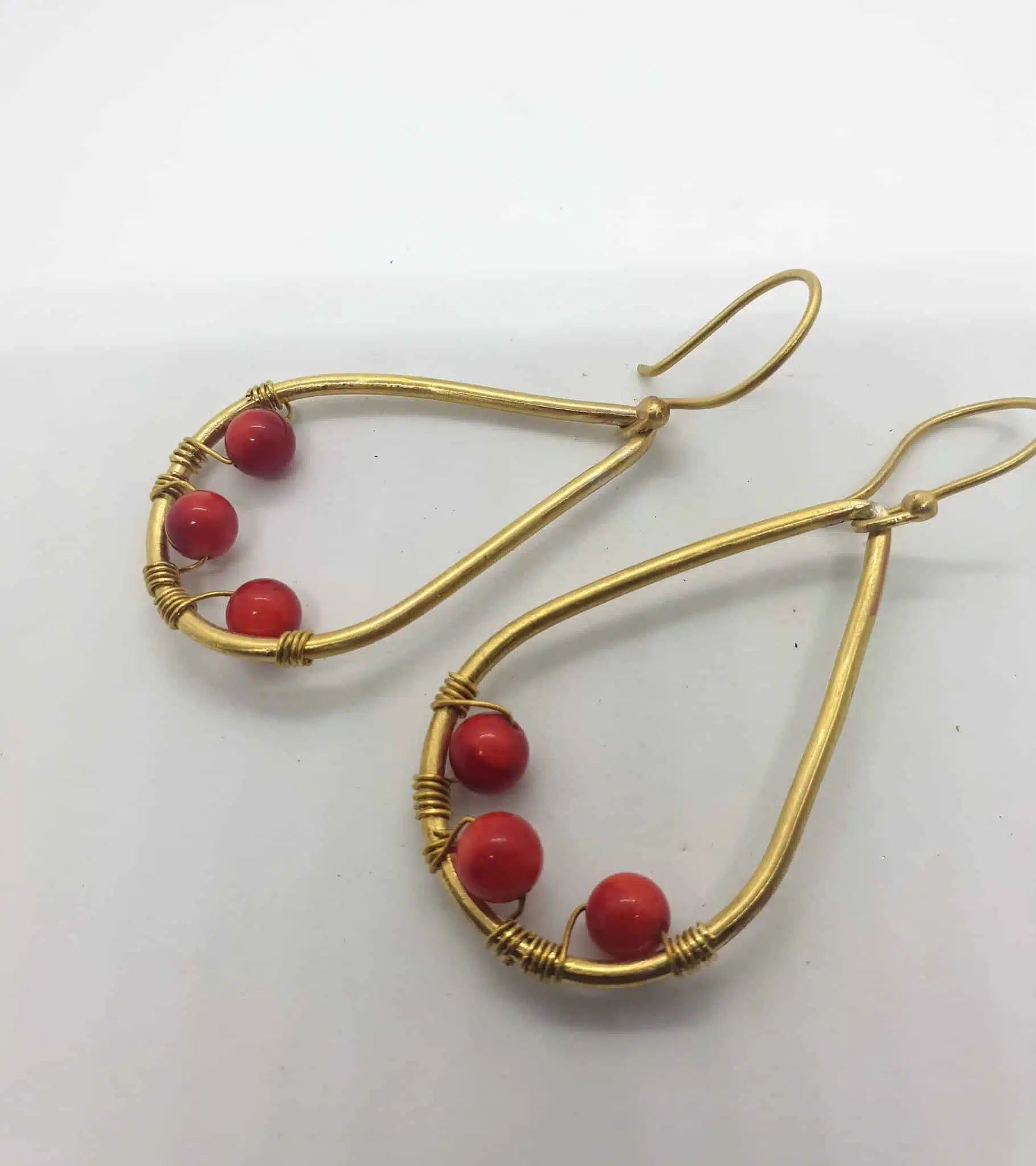 Teardrop shaped brass frame with 3 attached red amber 2 20230615 133430 copy 1 scaled