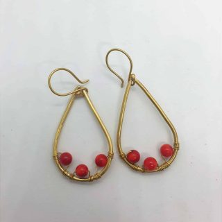 Teardrop shaped brass frame with 3 attached red amber
