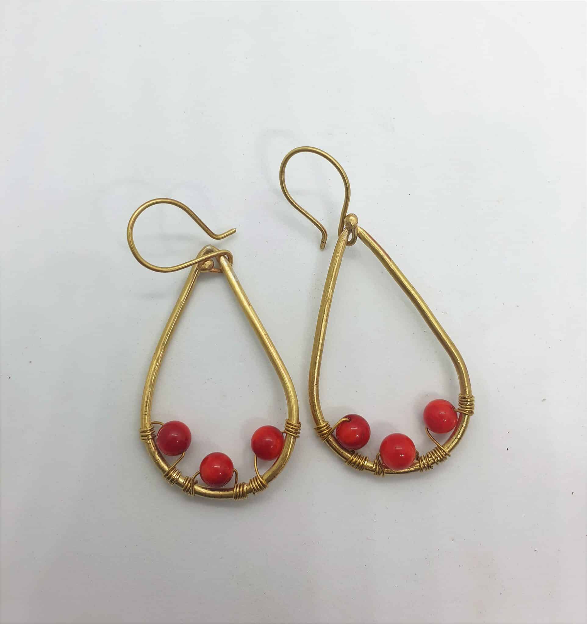 Teardrop shaped brass frame with 3 attached red amber 1 Teardrop shaped brass frame with 3 attached red amber