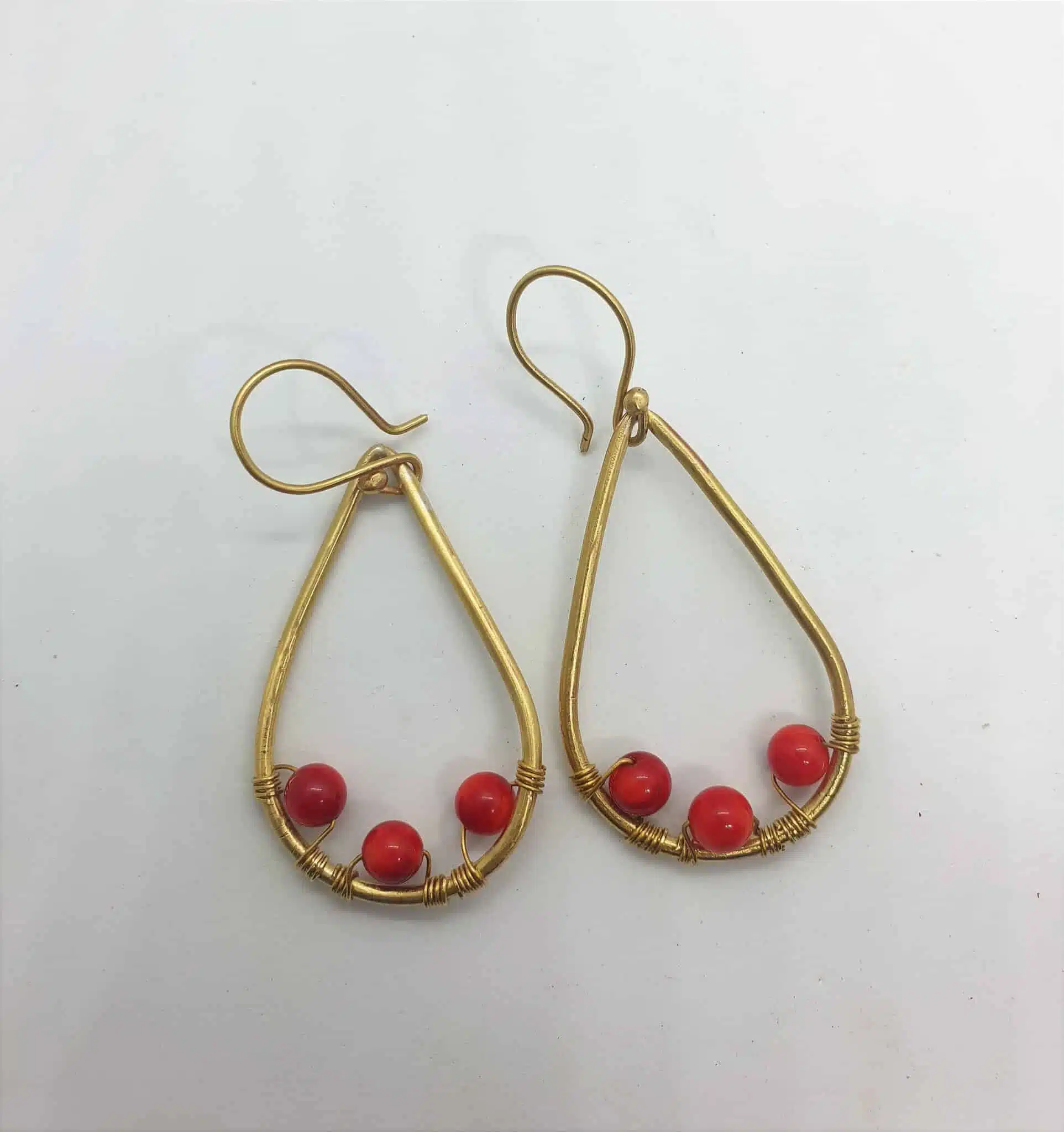 Teardrop shaped brass frame with 3 attached red amber 1 Teardrop shaped brass frame with 3 attached red amber