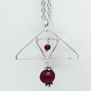 Silver pendant with ruby beads
