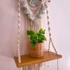 Macrame wall shelf with mint tassels