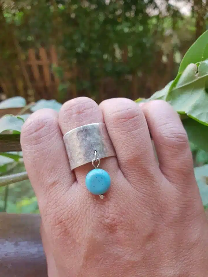 Silver hammered ring with dangling turquoise 2 Hammered with dangling turquoise stone 3