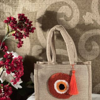 Orange evil eye jute bag