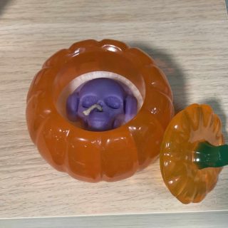 A resin pumpkin pot with candle