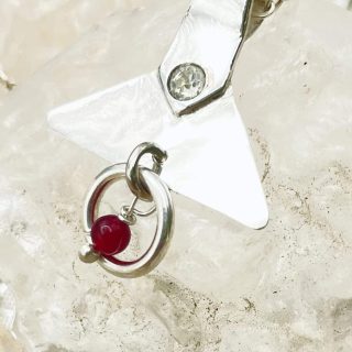 Silver pendant with ruby beads and crystal