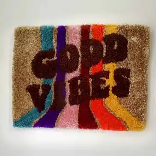 "GOOD VIBES" tufted wall hanging