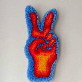 "x-ray hand" tufted wall hanging