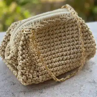 Ivory colored crochet bag with a touch of gold