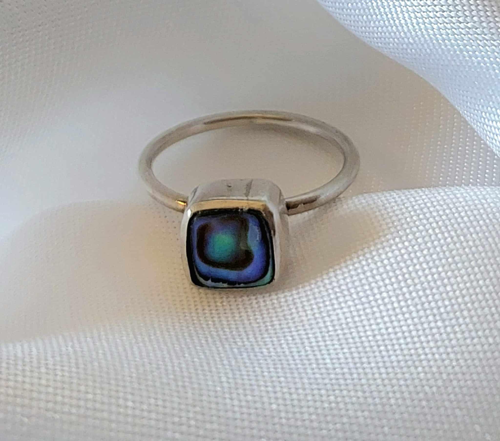 Silver Abalone Square Minimal Ring 2 Discover the elegance of simplicity with our Silver Abalone Square Minimal Ring. Crafted with precision, this sleek design features a stunning abalone stone that catches the light with every movement. Perfect for adding a subtle yet sophisticated touch to any loo
