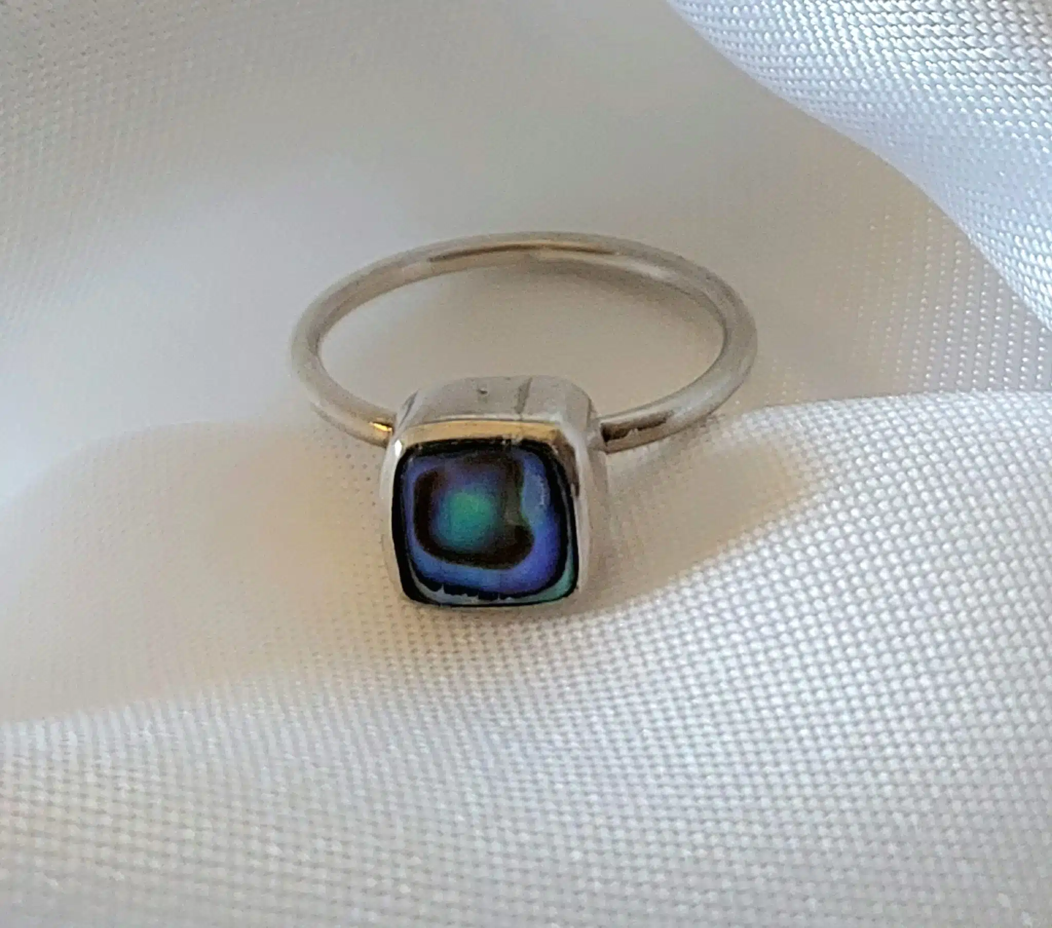 Silver Abalone Square Minimal Ring 2 Discover the elegance of simplicity with our Silver Abalone Square Minimal Ring. Crafted with precision, this sleek design features a stunning abalone stone that catches the light with every movement. Perfect for adding a subtle yet sophisticated touch to any loo