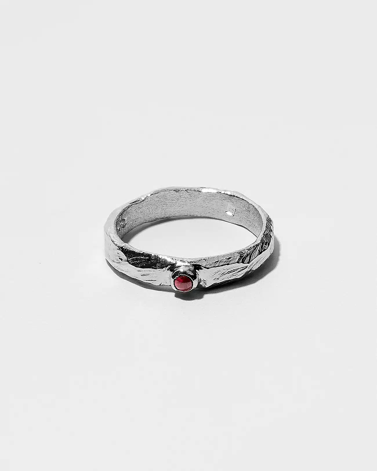 Essential Collection , Organic Textured Band Ring With Small Garnet Stone 2 Organic Textured Ring With Small Garnet Stone SZR231.2