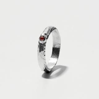 Essential Collection , Organic Textured Band Ring With Small Garnet Stone