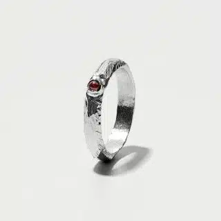 Essential Collection , Organic Textured Band Ring With Small Garnet Stone