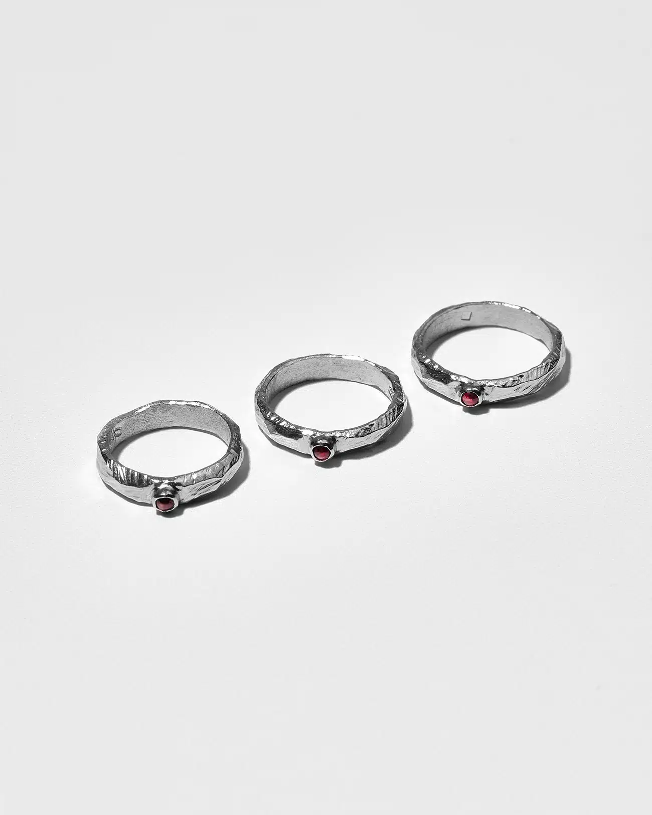 Essential Collection , Organic Textured Band Ring With Small Garnet Stone 3 Organic Textured Ring With Small Garnet Stone SZR231.4