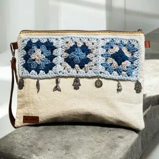 Beige clutch with granny squares and silver charms