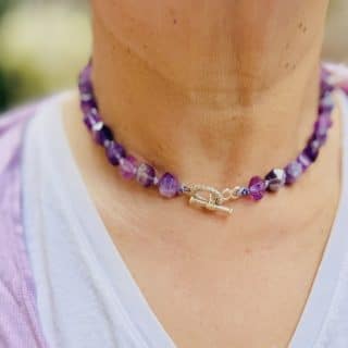 Hand knotted amethyst necklace, sterling silver clasp on the front