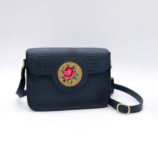 Dark blue genuine leather bag with floral design.