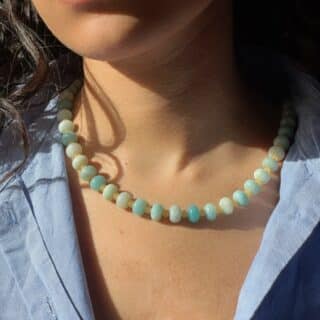 try on shot of the hand-beaded Citrine Skies Necklace No.01 in butter yellow agate stones blue stones A soft summer day, captured in stone. Inspired by the golden warmth of citrine sunsets and the tranquility of clear skies. Blends butter yellow and sky blue tones in a dreamy, refreshing palette. Handcrafted with butter yellow natural jade gemstones and finished with 925 sterling silver clasp. -Material: Natural jade stones - Length: 42 cm - 925 sterling silver clasp