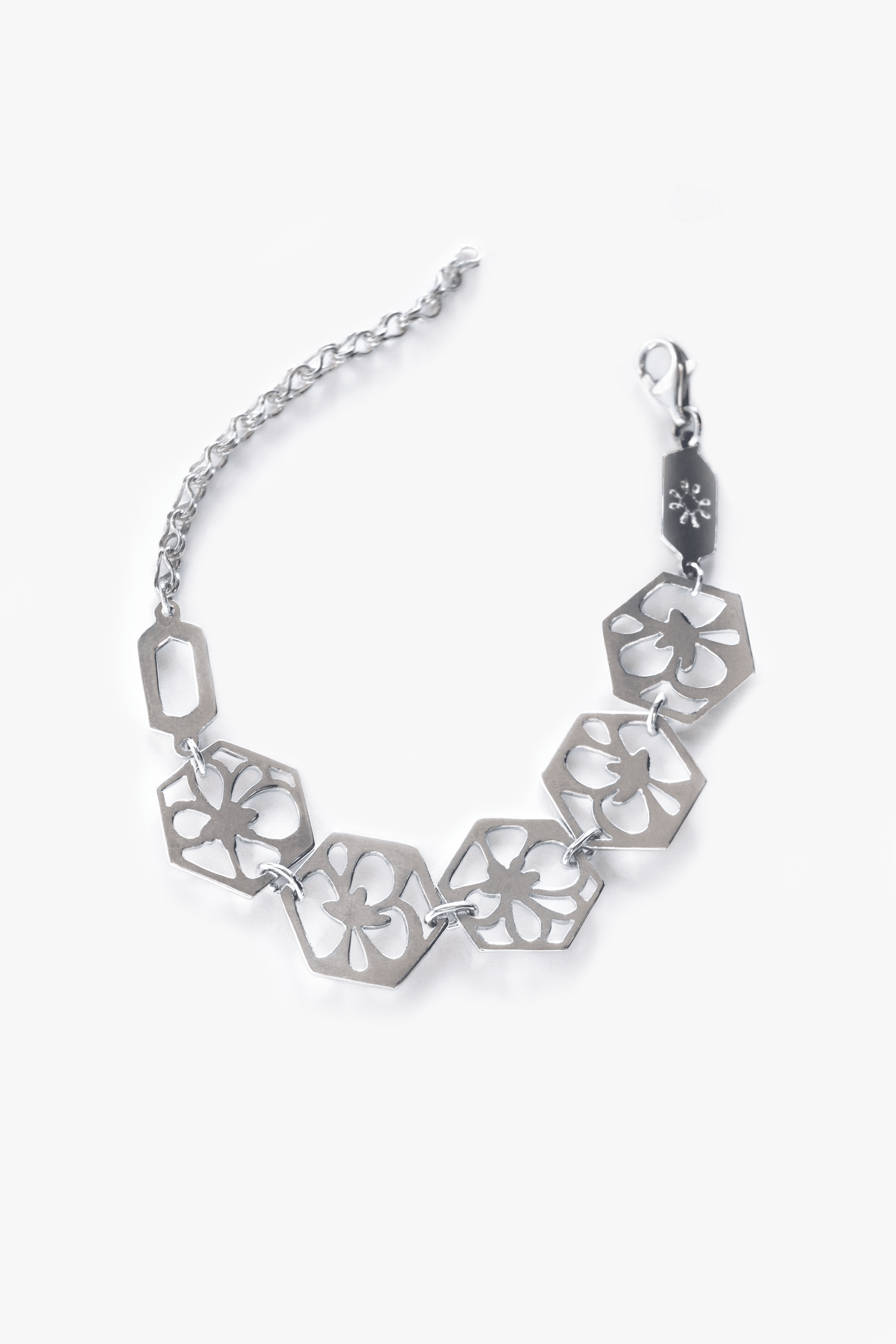 Camellia Statement Bracelet 1 Sterling silver bracelet with flower motifs.