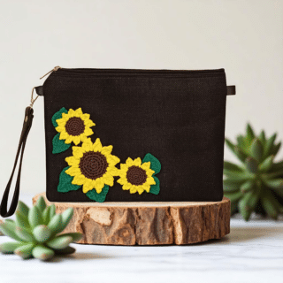 Black clutch with crochet sunflowers